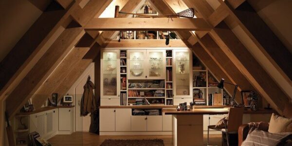 A room with many shelves and a desk in it