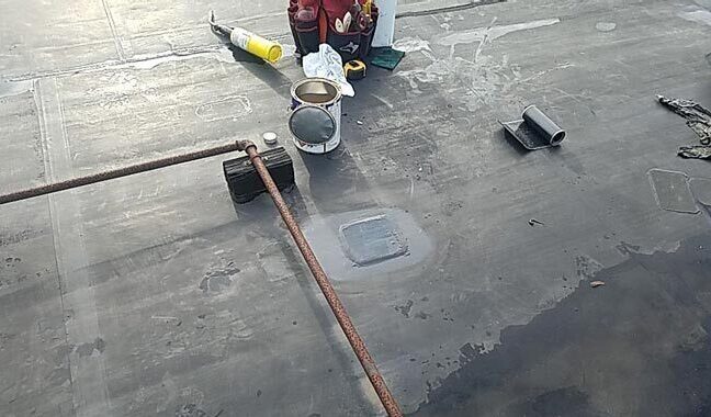 A person is working on the roof of a building.