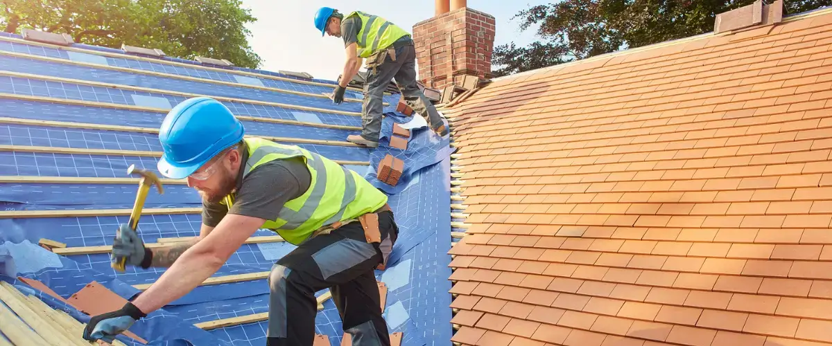 Two men working on a roof.