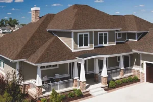 A large house with brown shingles and white trim.